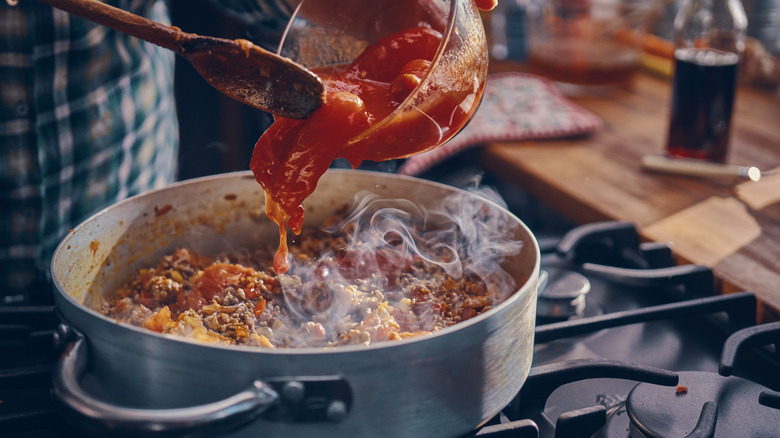 tomatoes poured in bolognese sauce