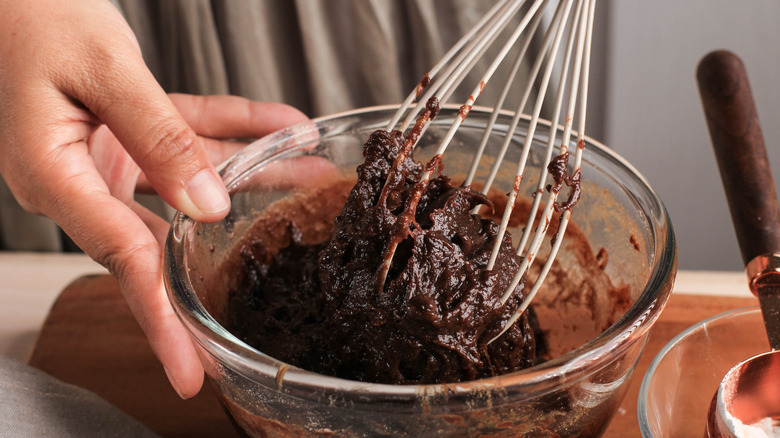 Person whisking brownie mix