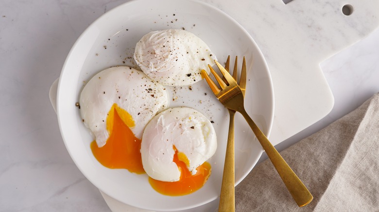 Three poached eggs on plate