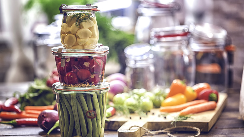 Pickled garlic, cherries, and green beans in jars