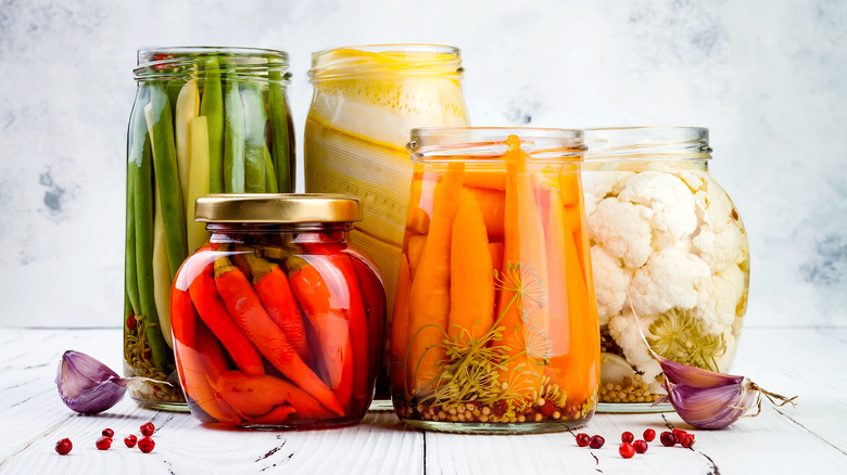 various pickled vegetables in glass jars