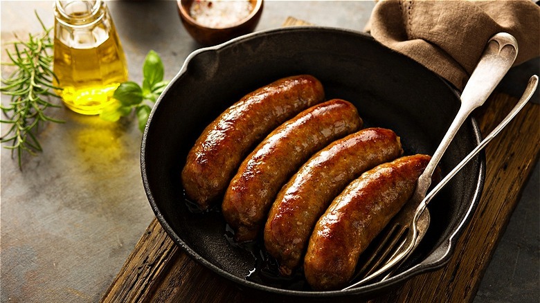 Sausages in pan with forks