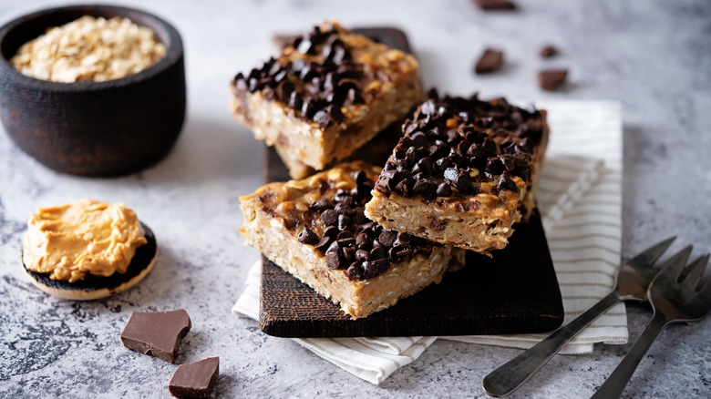 Chocolate peanut butter bars on a grey table