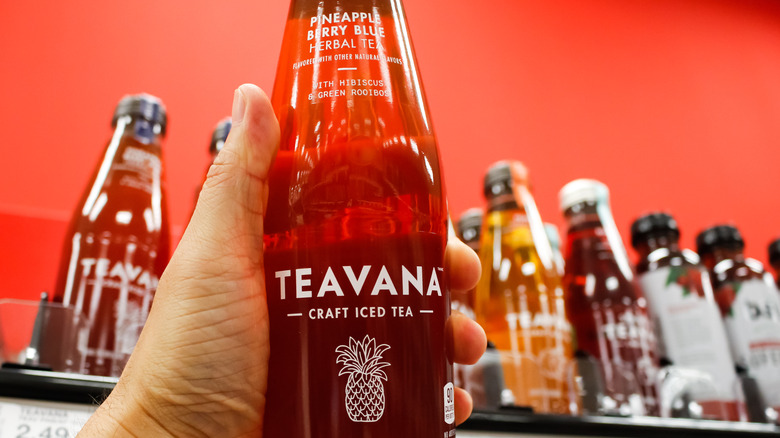 Hand holding Teavana's Pineapple Berry Blue iced tea