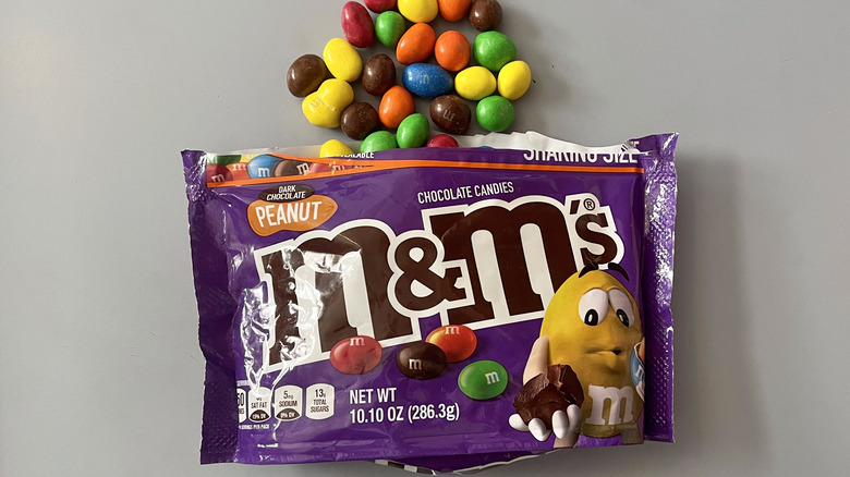 open bag of dark chocolate peanut M&M's