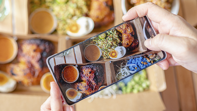 Person photographing food with a smartphone