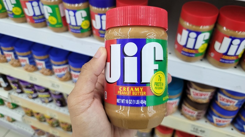 hand holding Jif jar