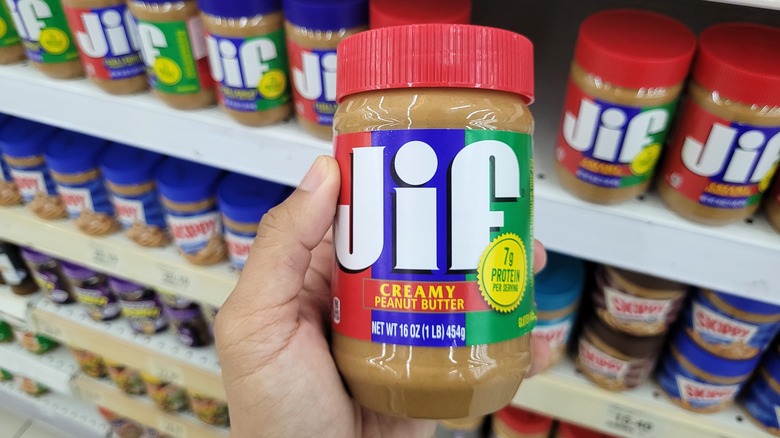 Person holding Jif peanut butter