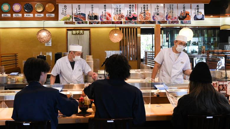 customers seated at sushi restaurant