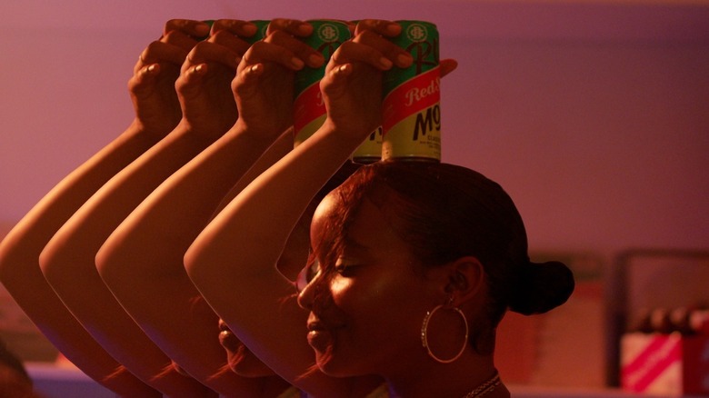 Hands holding cans of Red Stripe Rum Drinks