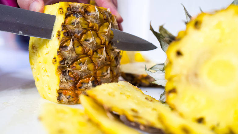 Pineapple being sliced