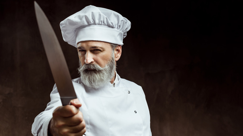 Cook holding chef knife