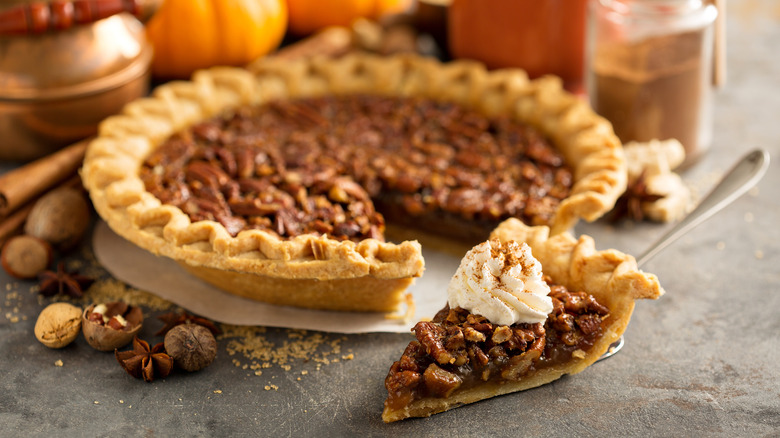 Pecan pie with slice and whipped cream