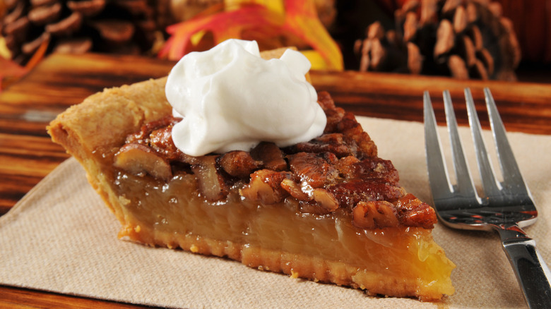 slice of pecan pie with whipped cream