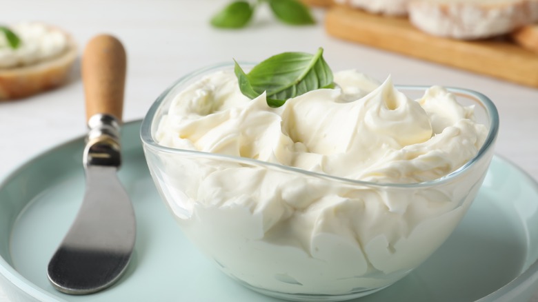 Dish of cream cheese with spreading knife