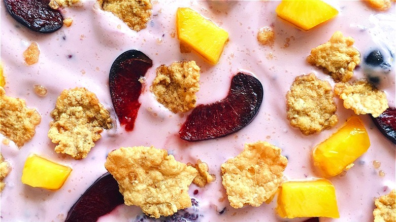 Pink yogurt with cereal and fruit 