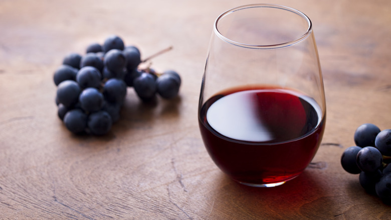 Glass of Beaujolais red wine with grapes