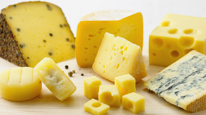 Variety of cheeses on cutting board