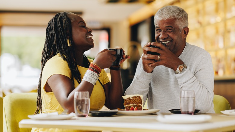 Two people laughing dining out