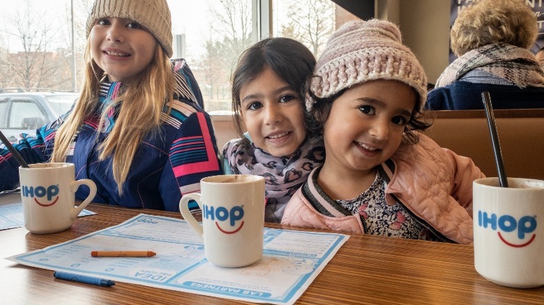 Three girls with IHOP mugs