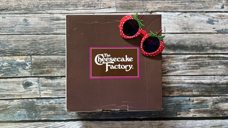 Cheesecake Factory box and sunglasses