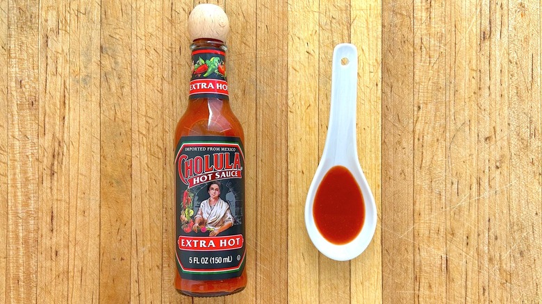 Bottle and spoon of Cholula Extra Hot Sauce