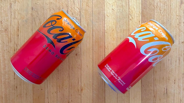 Cans of regular and zero sugar Coca-Cola Orange Cream