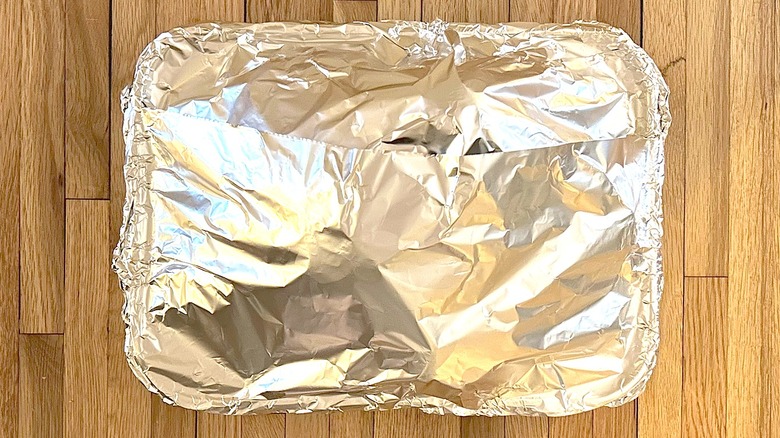 Popeyes signature Cajun-Style Turkey in a roasting pan covered with aluminum foil