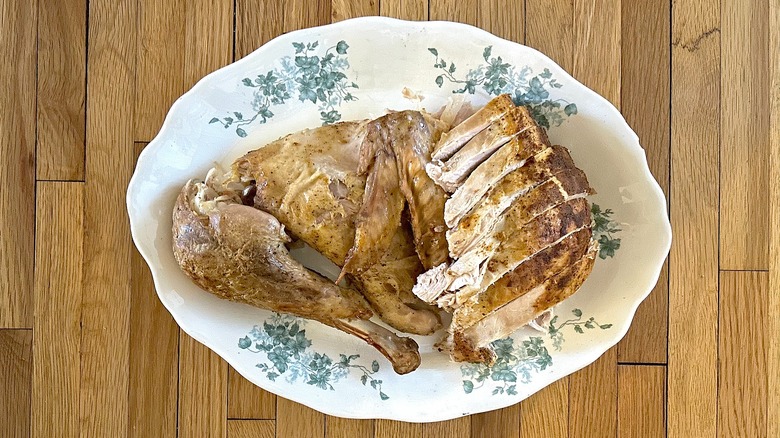 Decorative platter full of pieces and slices of Popeyes signature Cajun-Style Turkey