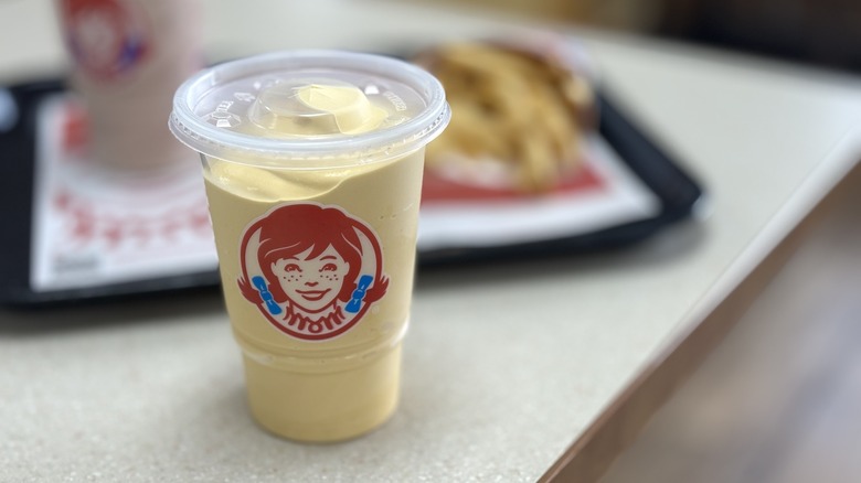 Wendy's Salted Caramel Frosty with food in background