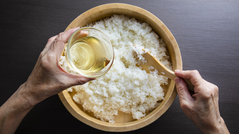 Rice vinegar poured into rice