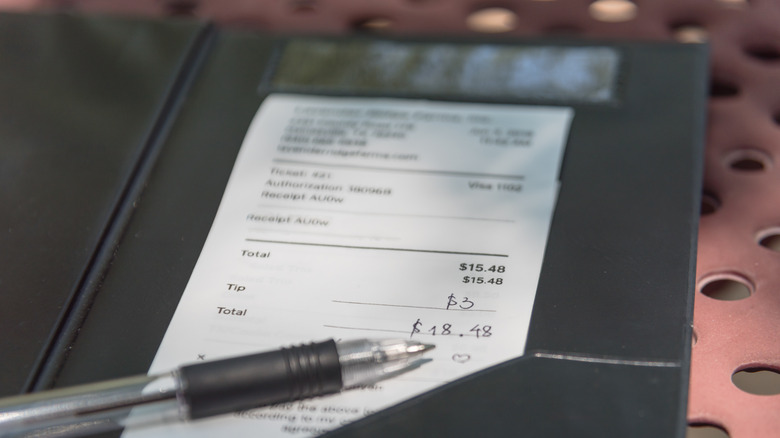 Restaurant bill showing 20% tip