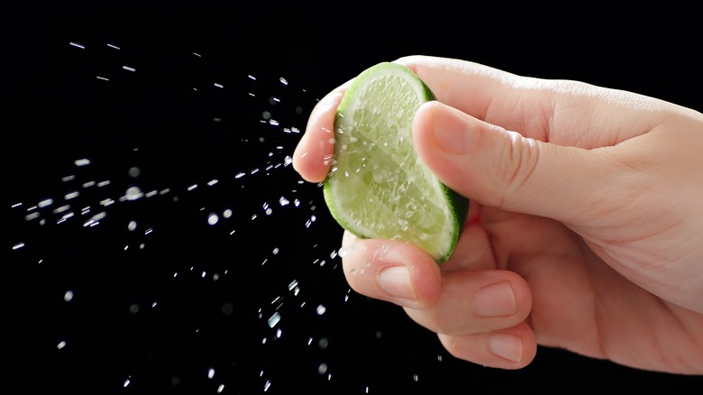 Hand squeezing a lime