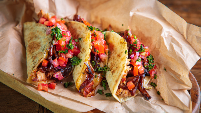 Tacos with caramelized onions, veggies, and salsa