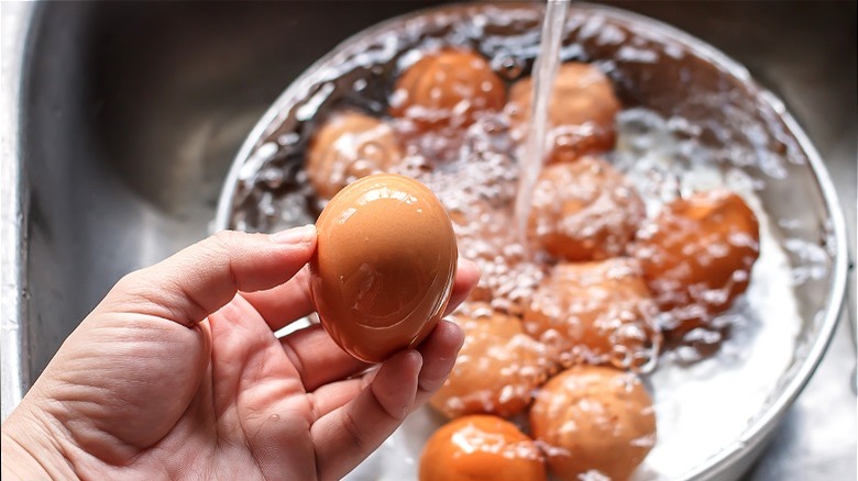 Brown eggs under running water 