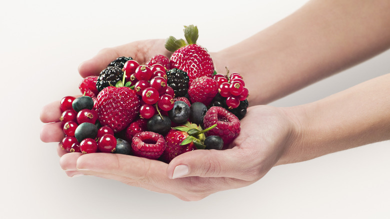 Hands holding pile of berries