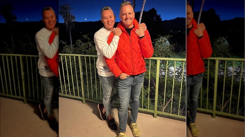 Ross Mathews smiling with his husband outside at night