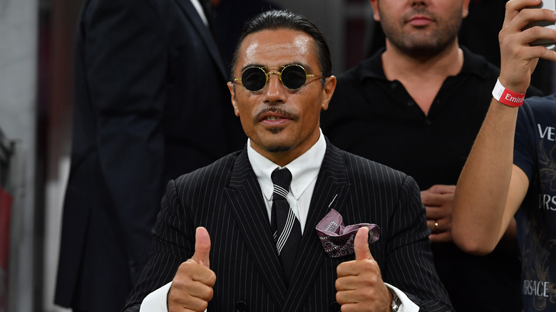 Salt Bae giving two thumbs up.