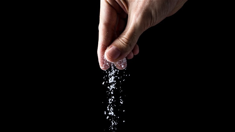 Hand sprinkling salt