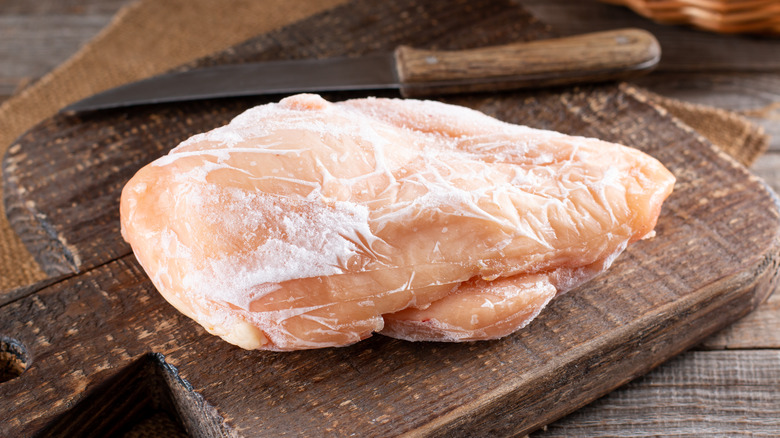 frozen chicken on cutting board