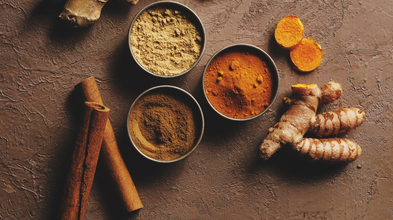 warming spices on brown background