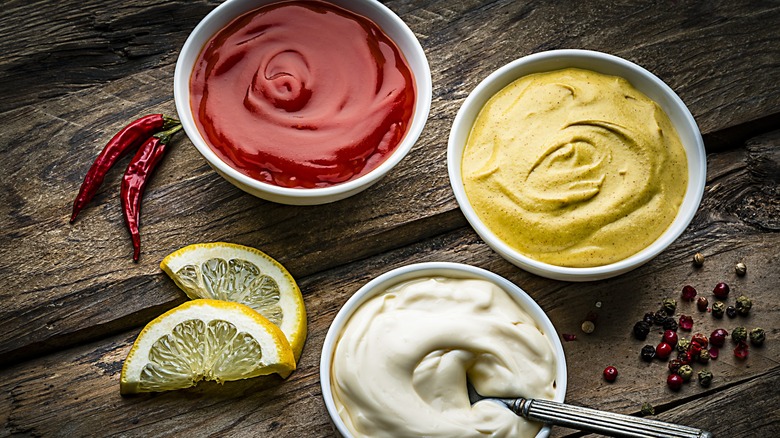 Ketchup mustard mayonnaise in bowls