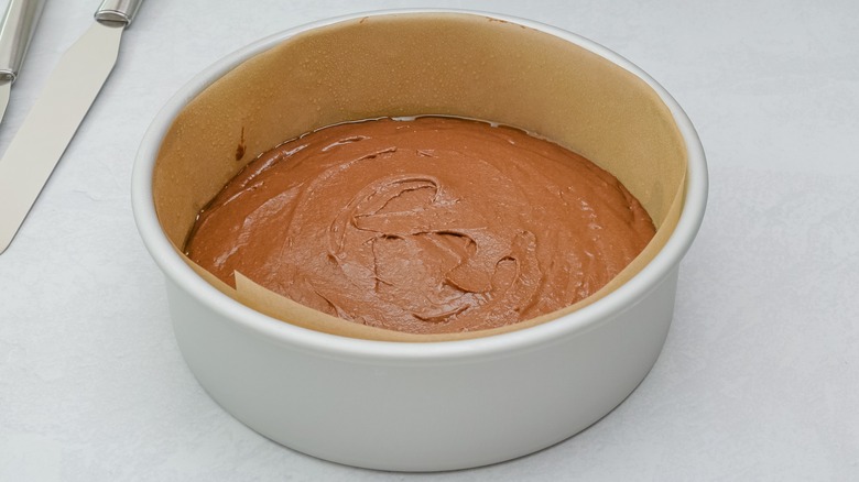 baking pan with parchment paper and cake batter