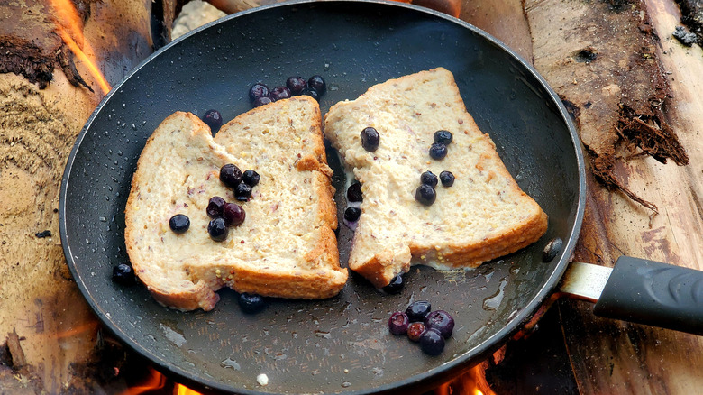 French toast cooking over campfire