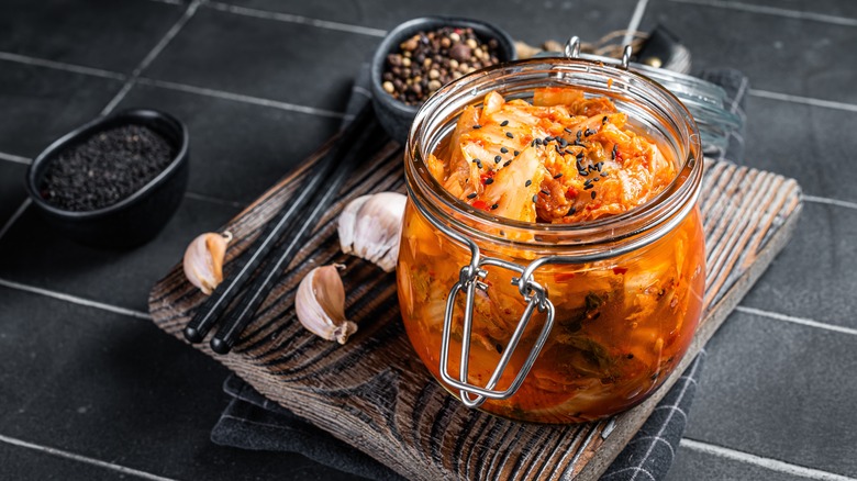 kimchi in a glass jar with pepper and garlic