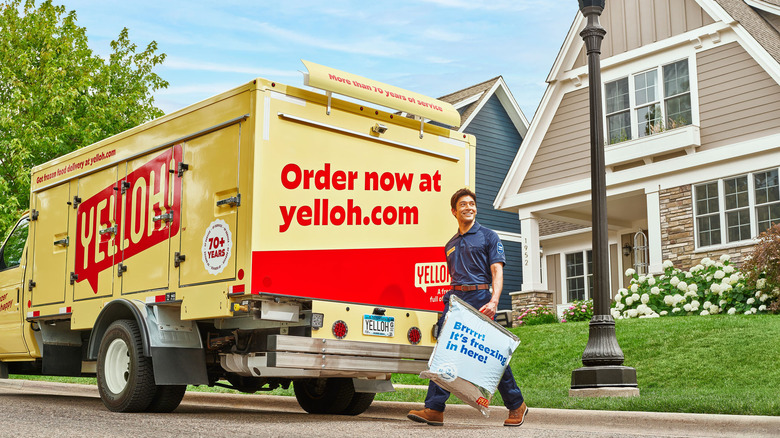 delivery driver next to a yelloh truck