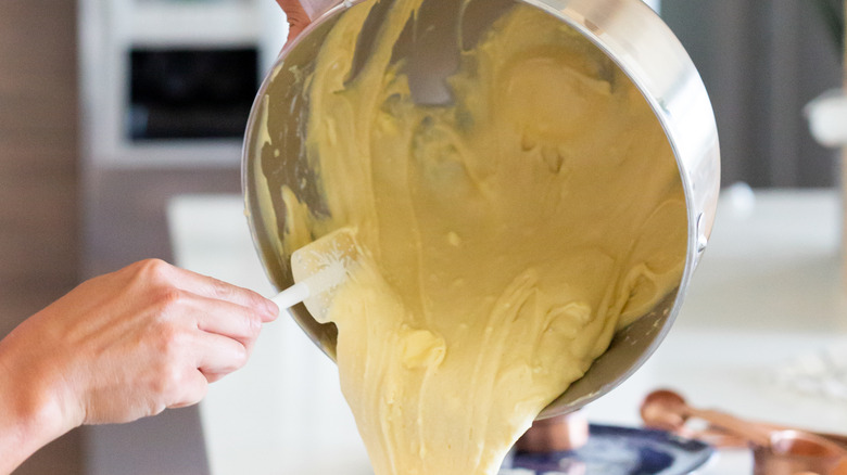 scraping sides of mixing bowl 