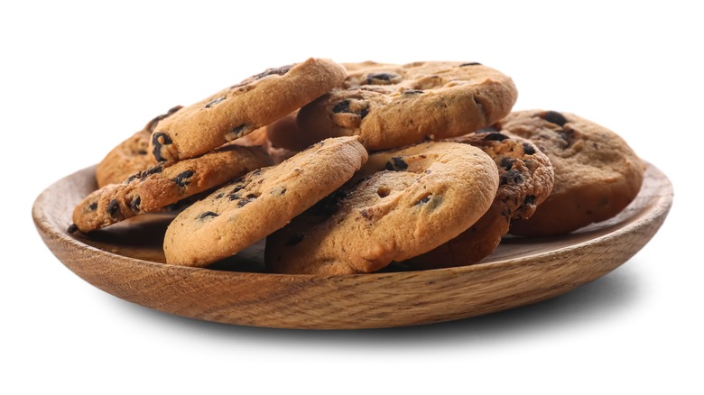 wooden plate of chocolate chip cookies