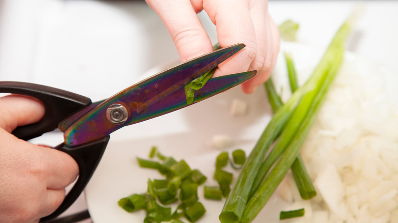 Person cutting scallions with shears