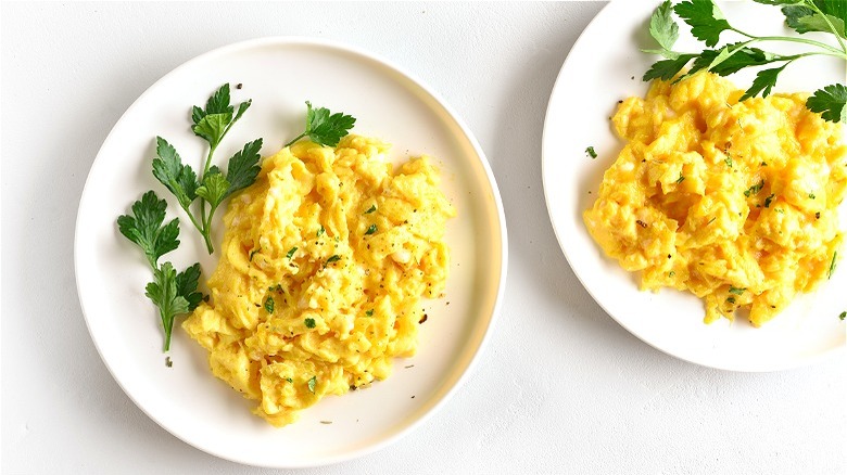 Two plates of scrambled eggs 